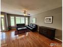 Spacious living room with hardwood floors, large windows, and comfortable seating arrangement at 2855 Rock Creek Cir # 200, Superior, CO 80027