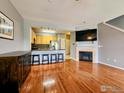 Open-concept living room with hardwood floors, fireplace, and seamless flow to the kitchen at 2855 Rock Creek Cir # 200, Superior, CO 80027