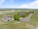 Expansive aerial view captures the neighborhood and the property's prime location near the airfield and mountains at 2875 Mooney Pl, Erie, CO 80516