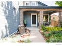 Inviting home entrance boasting stone arches, attractive landscaping, and a tranquil water feature at 2933 Hunt Ct, Erie, CO 80516