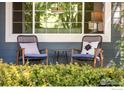 Relaxing front porch showcasing comfortable seating and a view of the beautiful, green landscape at 2933 Hunt Ct, Erie, CO 80516