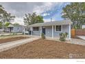 Single-story home with a covered porch, landscaping, and a convenient carport at 3245 W Walsh Pl, Denver, CO 80219