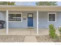 Welcoming front porch with blue front door, and maintained landscaping at 3245 W Walsh Pl, Denver, CO 80219