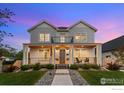 Beautifully renovated two-story home with a spacious front porch and a manicured lawn at 3256 S Corona St, Englewood, CO 80113