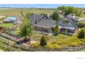 Aerial view of the backyard featuring a pergola, seating, fire pit, and planting beds at 3412 Erving Ct, Berthoud, CO 80513