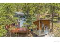 Unique mountain home with rustic wood accents and a charming wooden deck nestled among the trees at 398 Fred Rd, Boulder, CO 80302