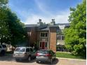Exterior view of apartment building with well-maintained grounds and several parked cars at 50 19Th Ave # 9, Longmont, CO 80501