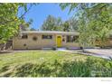 Charming single-story home features a sunny yellow front door, brick exterior, and green lawn at 630 S 45Th St, Boulder, CO 80305