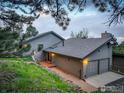 Charming home featuring a brick path leading to the front entrance and two-car garage at 8664 Middle Fork Rd, Boulder, CO 80302