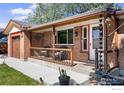 Inviting covered front porch with brick accents and cozy seating area at 1234 S Holland Ct, Lakewood, CO 80232