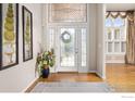 Inviting foyer featuring a decorative glass door, hardwood floors, and elegant decor setting a welcoming tone at 13 Blue Heron Dr, Thornton, CO 80241