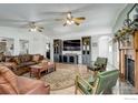 Bright living room with hardwood floors, a fireplace, built-in shelving, and comfortable seating at 1428 S County Road 23E, Berthoud, CO 80513