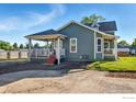 Quaint two-story house with a covered porch, complemented by a well-maintained lawn and landscaping at 1711 Antero Dr, Longmont, CO 80504