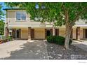 Inviting townhome with brick accents, individual garages and mature landscaping creating curb appeal at 1837 Spaulding Cir, Superior, CO 80027