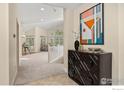 Welcoming entryway featuring neutral tones, modern decor and abundant natural light at 2106 River Walk Ln, Longmont, CO 80504