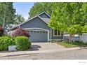 Beautiful single-Gathering home with lush landscaping and a two-car garage at 2106 River Walk Ln, Longmont, CO 80504