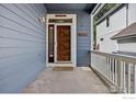 Inviting front porch with address number and ample space for outdoor seating at 2106 River Walk Ln, Longmont, CO 80504