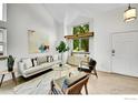Bright, open living room featuring modern decor, large windows, and neutral walls at 2335 Dogwood Cir, Louisville, CO 80027
