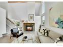 Cozy living room features a stone fireplace, neutral decor, and plenty of natural light at 2335 Dogwood Cir, Louisville, CO 80027