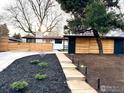 Landscaped front yard with modern fence, pathway, and minimalist plantings that add to the property's curb appeal at 2435 S Meade St, Denver, CO 80219