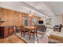 Open concept dining room with hardwood floors, dining table, and exposed ceiling beams at 2525 S Dayton S Way # 2301, Denver, CO 80231