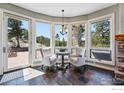 Charming breakfast nook with a stone accent wall, slate floors, and views of the surrounding mountain landscape at 290 Skyhill Dr, Evergreen, CO 80439