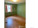 Bedroom with hardwood floors, natural light, and built-in shelving, offering storage solutions at 3250 Oneal Cir # 14, Boulder, CO 80301