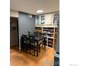 Charming dining room featuring hardwood floors, a modern light fixture, and custom built-in shelving at 3250 Oneal Cir # 14, Boulder, CO 80301
