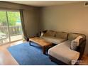 Cozy living room with a sliding glass door to the balcony, plush sofa, and stylish coffee table at 3250 Oneal Cir # 14, Boulder, CO 80301