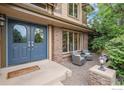 Inviting entryway with a blue double door, brick accents, and a cozy seating area for a welcoming touch at 3441 W Dartmouth Ave, Denver, CO 80236