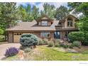 Charming home featuring brick accents, a well-manicured lawn, and mature trees, creating a picturesque curb appeal at 3441 W Dartmouth Ave, Denver, CO 80236