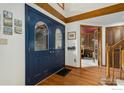 Welcoming foyer with a stylish blue double door, hardwood floors, and a glimpse into a cozy office space at 3441 W Dartmouth Ave, Denver, CO 80236