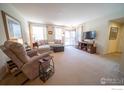 Bright living room featuring neutral paint, large windows and comfortable seating at 3671 Pinedale St # D, Boulder, CO 80301