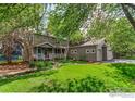 Two-story home with a well-maintained lawn, mature trees, and charming front porch at 4157 19Th St, Boulder, CO 80304