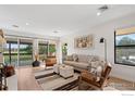 Bright living room featuring wood floors, neutral decor, and a sliding glass door to the outside at 500 Manhattan Dr # A9, Boulder, CO 80303