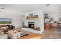 Stylish living room with a white brick fireplace, modern decor, and easy flow into the kitchen at 500 Manhattan Dr # A9, Boulder, CO 80303