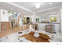 Bright, open living room with fireplace, light wood floors, and modern decor at 6851 Goldbranch Dr, Niwot, CO 80503