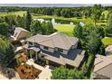 Aerial view of a two-story home with stone accents, immaculate landscaping, and golf course at 7205 Rustic Trl, Boulder, CO 80301