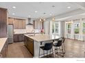 Modern kitchen with a center island, pendant lighting, and hardwood floors at 759 Old Wagon Trail Cir, Lafayette, CO 80026
