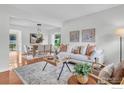 Inviting living room with hardwood floors, neutral tones, and dining area access at 790 W Moorhead Cir # A, Boulder, CO 80305