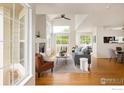 Bright living room featuring large windows, wood floors, a fireplace, and comfortable seating at 805 Summer Hawk Dr # 100, Longmont, CO 80504
