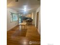 Open-concept dining area with hardwood floors, adjacent to the kitchen, providing a seamless flow at 936 Parkview St, Louisville, CO 80027