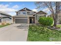 Charming two-story home with a well-manicured lawn and attached two-car garage at 9930 Cascade St, Firestone, CO 80504