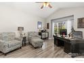 Bright home office featuring vaulted ceilings, hardwood floors, and a large desk at 9930 Cascade St, Firestone, CO 80504