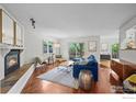 Bright and inviting living room with a cozy fireplace, modern furnishings, and access to outdoor patio at 1409 Quince Ave, Boulder, CO 80304