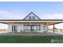 Charming exterior with a covered patio, wooden beams, and comfortable seating area at 14407 County Road 18 1/2 Rd, Fort Lupton, CO 80621