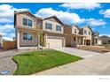 Charming two-story home with landscaped yard, covered porch and a two car garage at 18813 E 99Th Ave, Commerce City, CO 80022