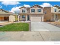 Charming two-story home with landscaped yard, covered porch and a two car garage at 18813 E 99Th Ave, Commerce City, CO 80022