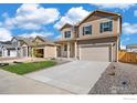 Charming two-story home with landscaped yard, covered porch and a two car garage at 18813 E 99Th Ave, Commerce City, CO 80022