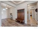 Mudroom style entryway with wood floors and a built-in bench with storage at 2200 Cadman St, Berthoud, CO 80513
